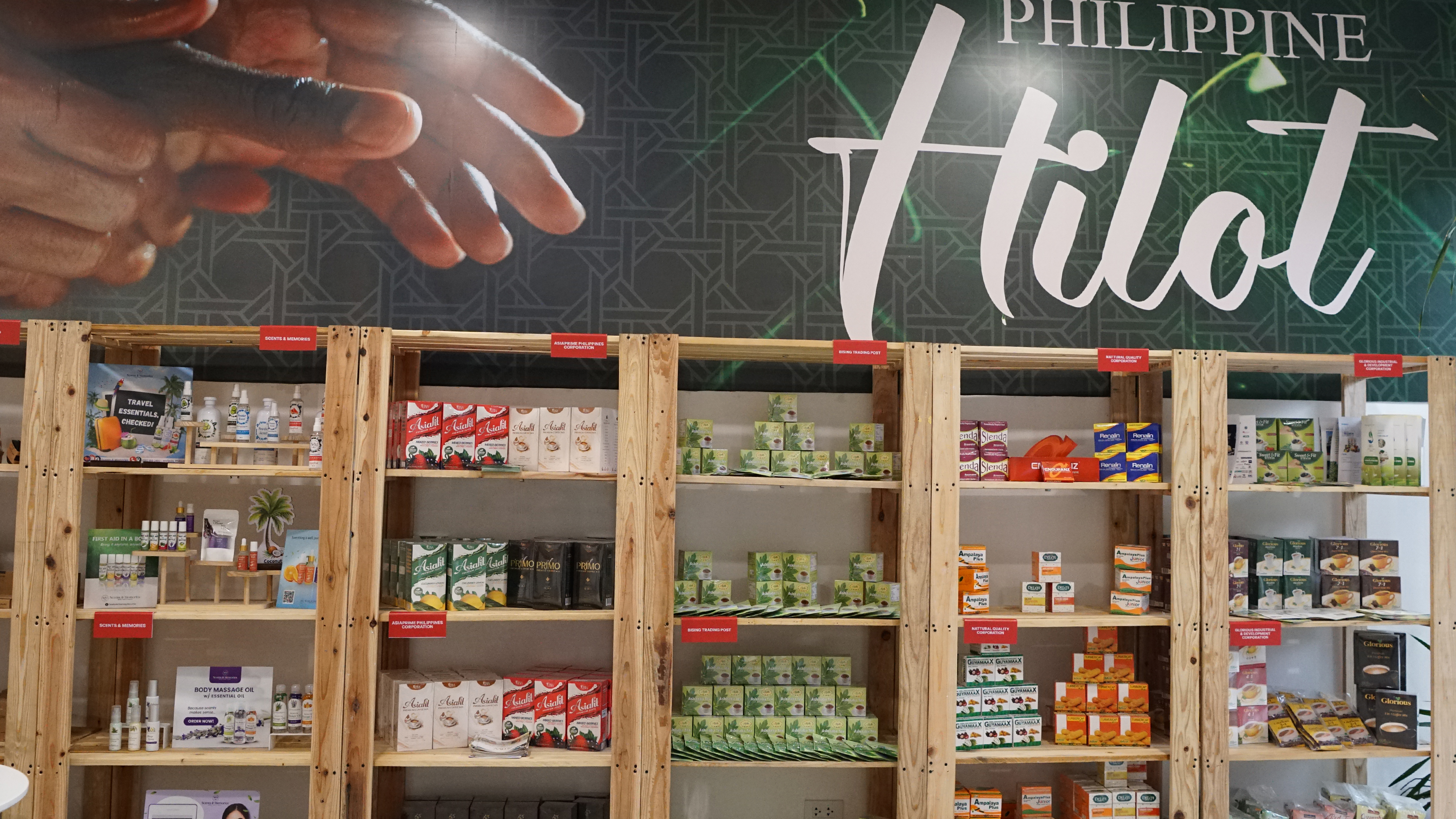 Wooden shelves stocked with herbal teas, oils, and wellness products under a 